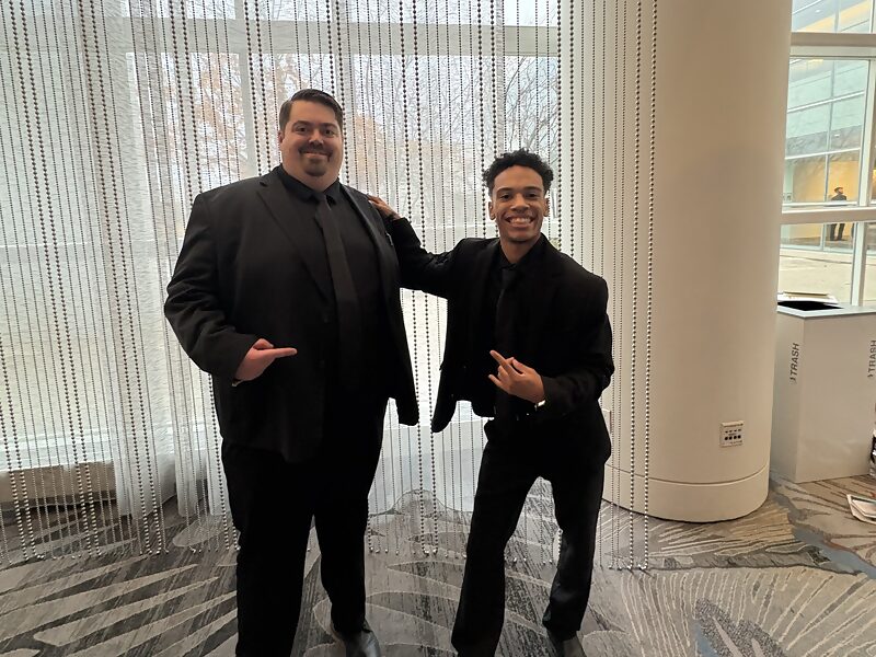 Two Dynamic Growth & Connections Inc. team members at a company event