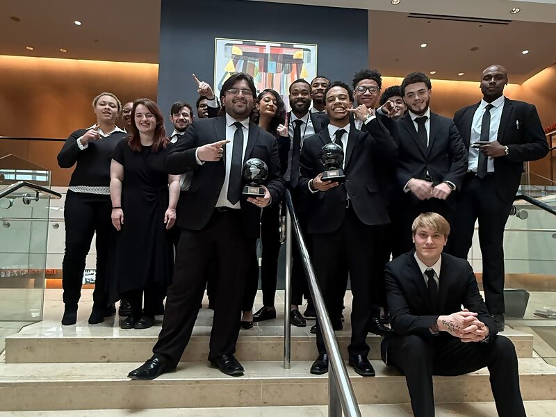 Dynamic Growth & Connections Inc. team members holding awards received at a company recognition event